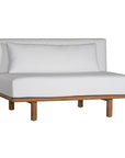 A contemporary armless sofa with plush white cushions and a sturdy natural teak wood frame. This minimalist lounge piece offers versatile seating, perfect for modern living spaces or outdoor settings