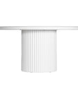 KULALA Living Modern white round dining table featuring a smooth tabletop and a fluted pedestal base. A contemporary statement piece designed to bring elegance and sophistication to any dining space