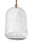 A stylish white hanging chair with an open-weave design, suspended by a natural rope and featuring a plush white cushion for ultimate relaxation