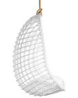 A stylish white hanging chair with an open-weave design, suspended by a natural rope and featuring a plush white cushion for ultimate relaxation