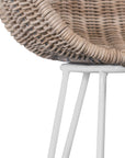 White natural rattan bar chair with curved back and slim metal legs, perfect for modern and stylish dining settings