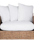 A contemporary white natural woven sofa with plush, generously filled cushions, offering both comfort and style for a refined coastal or modern living space.