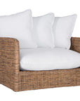 A contemporary white natural woven sofa with plush, generously filled cushions, offering both comfort and style for a refined coastal or modern living space.