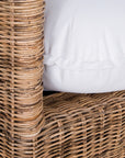 A contemporary white natural woven sofa with plush, generously filled cushions, offering both comfort and style for a refined coastal or modern living space.
