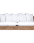 A contemporary white natural woven sofa with plush, generously filled cushions, offering both comfort and style for a refined coastal or modern living space.