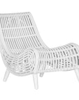 A sculptural white rattan lounge chair with a curved, low-profile silhouette and sleek wooden legs. The woven design adds texture, while the deep seat and ergonomic shape offer comfort and relaxation