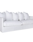 A contemporary white woven sofa with plush, generously filled cushions, offering both comfort and style for a refined coastal or modern living space.