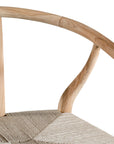 A natural timber wishbone dining chair with a handwoven rope seat, featuring an iconic curved backrest and minimalist Scandinavian-inspired design. Perfect for modern coastal and contemporary interiors, offering both style and comfort