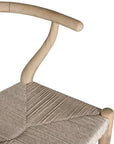 A natural timber wishbone bar stool with a handwoven rope seat, featuring a curved backrest and minimalist Scandinavian-inspired design. Crafted for both comfort and style, this versatile piece is perfect for modern coastal and contemporary interiors