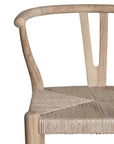A natural timber wishbone bar stool with a handwoven rope seat, featuring a curved backrest and minimalist Scandinavian-inspired design. Crafted for both comfort and style, this versatile piece is perfect for modern coastal and contemporary interiors