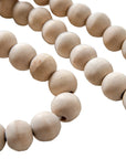 Natural wood bead garland with tassel, perfect for adding rustic charm and texture to home decor