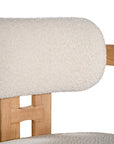 Contemporary wooden arm chair with a natural oak frame and boucle upholstered seat and backrest, designed for modern comfort and style