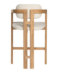 Contemporary wooden bar chair with a natural oak frame and boucle upholstered seat and backrest, designed for modern comfort and style.