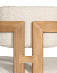 Contemporary wooden dining chair with a natural oak frame and boucle upholstered seat and backrest, designed for modern comfort and style