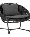 Round woven lounge chair in black with matching dark grey cushion, featuring a curved metal base for modern and stylish outdoor or indoor seating. Durable and comfortable design perfect for relaxed lounging
