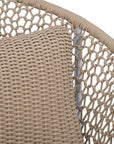 Round woven lounge chair in natural with matching natural cushion, featuring a curved metal base for modern and stylish outdoor or indoor seating. Durable and comfortable design perfect for relaxed lounging
