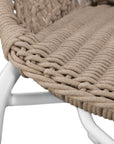 Round woven lounge chair in natural with matching natural cushion, featuring a curved metal base for modern and stylish outdoor or indoor seating. Durable and comfortable design perfect for relaxed lounging