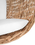 Natural wicker hanging egg chair with white cushion, suspended by a metal chain, perfect for indoor or outdoor relaxation