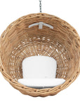 Natural wicker hanging egg chair with white cushion, suspended by a metal chain, perfect for indoor or outdoor relaxation