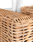 Natural wicker armchair with thick white cushions, showcasing a coastal-inspired design perfect for indoor and outdoor settings