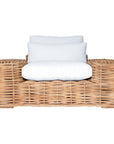 Natural wicker armchair with thick white cushions, showcasing a coastal-inspired design perfect for indoor and outdoor settings