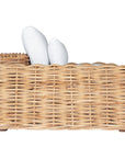 Natural wicker armchair with thick white cushions, showcasing a coastal-inspired design perfect for indoor and outdoor settings