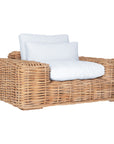Natural wicker armchair with thick white cushions, showcasing a coastal-inspired design perfect for indoor and outdoor settings