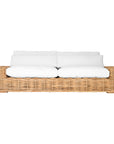 Natural wicker sofa with thick white cushion, showcasing a coastal-inspired design perfect for indoor and outdoor settings