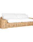 Natural wicker armchair with thick white cushions, showcasing a coastal-inspired design perfect for indoor and outdoor settings