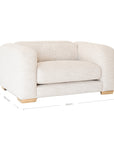 Modern white upholstered armchair with soft, rounded cushions and light wooden legs