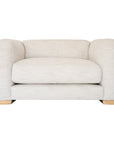 Modern white upholstered armchair with soft, rounded cushions and light wooden legs