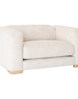 Modern white upholstered armchair with soft, rounded cushions and light wooden legs.