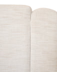 Modern white upholstered sofa with soft, rounded cushions and light wooden legs
