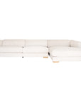 Modern white upholstered sofa with soft, rounded cushions and light wooden legs