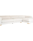 Modern white upholstered sofa with soft, rounded cushions and light wooden legs
