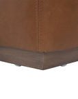 Modern leather upholstered sofa with soft, rounded cushions and light wooden legs