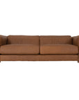 Modern leather upholstered sofa with soft, rounded cushions and light wooden legs