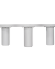 Zuburu coffee table in white concrete finish with organic curved tabletop and cylindrical pillar legs.