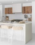 Hotham Barchairs arranged along a kitchen island with Ukoko Vases displayed behind and the Mayi Bowl styled on the benchtop.