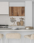 Hotham Barchairs at a white kitchen island with Ukoko Vases and the Mayi Bowl styled throughout the neutral kitchen setting.