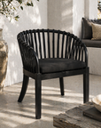 Black wicker chair with cushion on a patio
