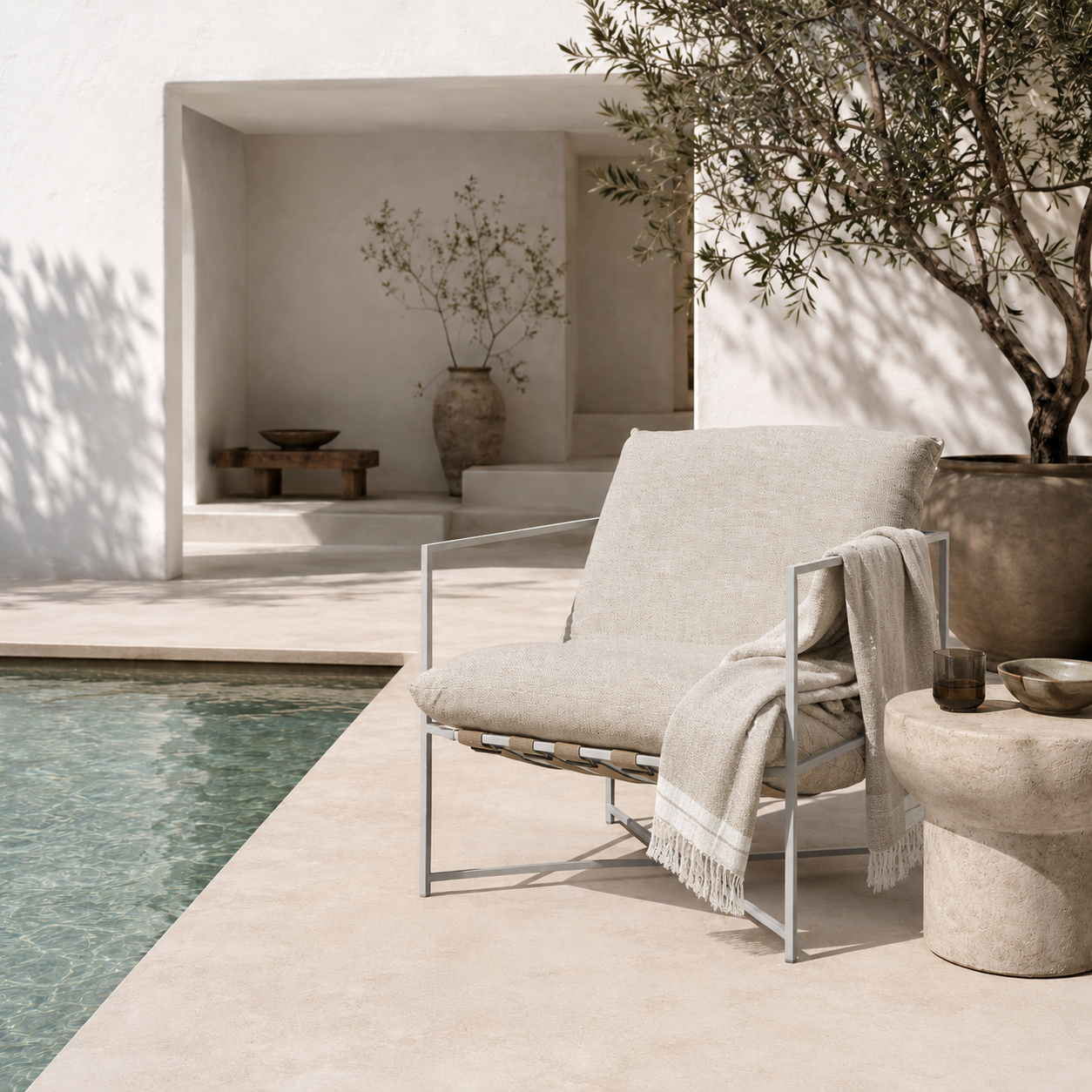 Chair by a pool with a neutral color palette
