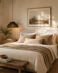 Cozy bedroom with a bed, nightstands, and wall art.