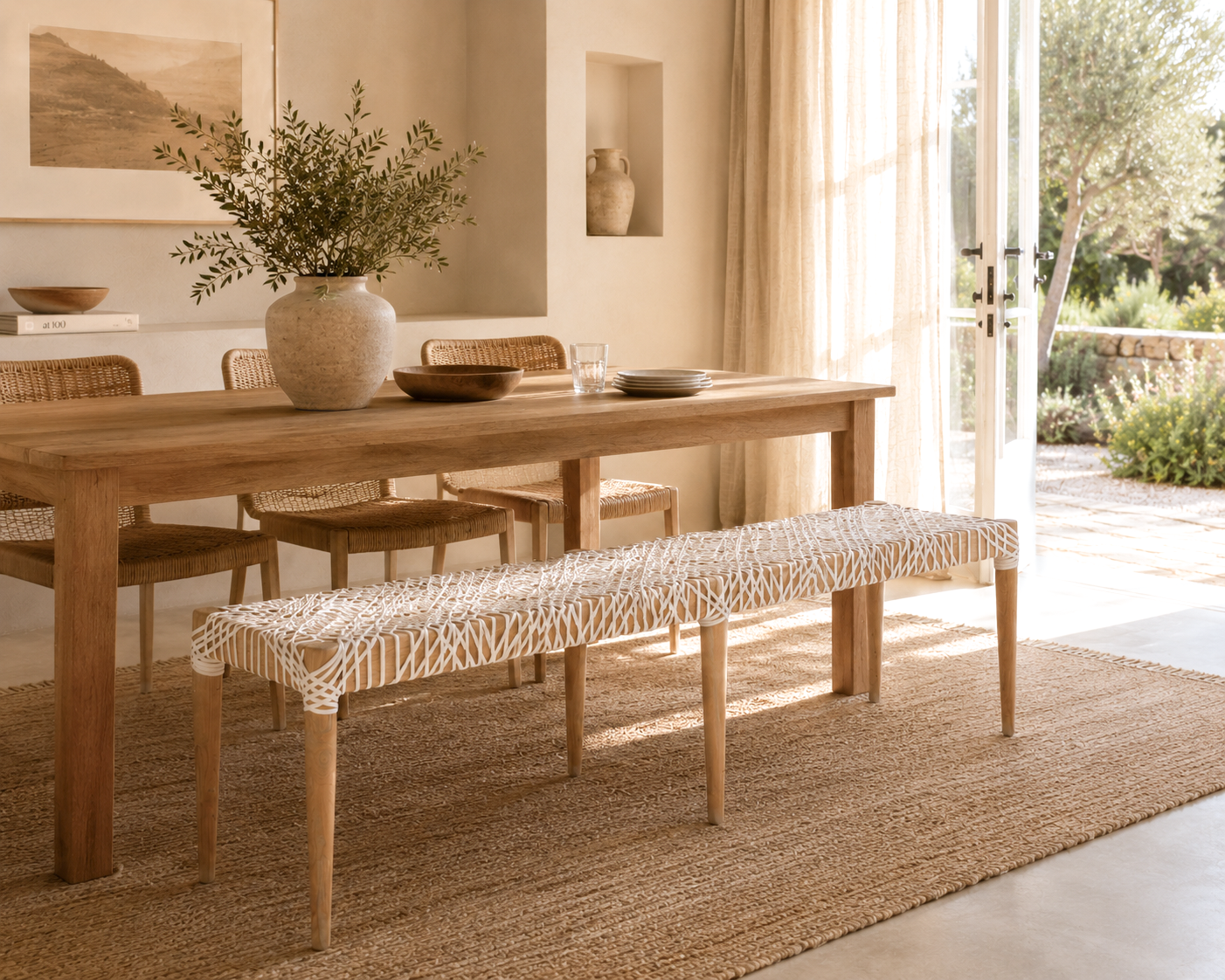 Dining room with wooden table and bench, natural light streaming in.