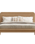 KULALA Living Flynn Oak Bed in natural finish showing the front view with a sturdy wooden frame and sleek design.