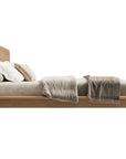 KULALA Living Flynn Oak Bed in natural wood finish, showing a side view with clean lines and sturdy frame.