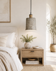 Nestled bedroom with a bed, nightstand, and decorative elements.