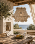 Outdoor dining area with a wooden table, chairs, and a scenic view of the ocean.
