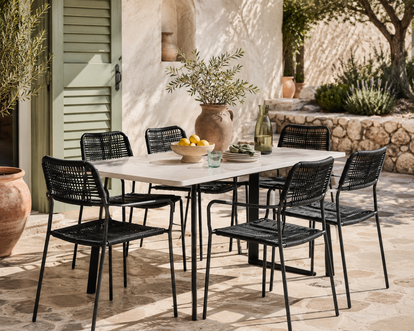 Outdoor dining set with a table and chairs on a patio.