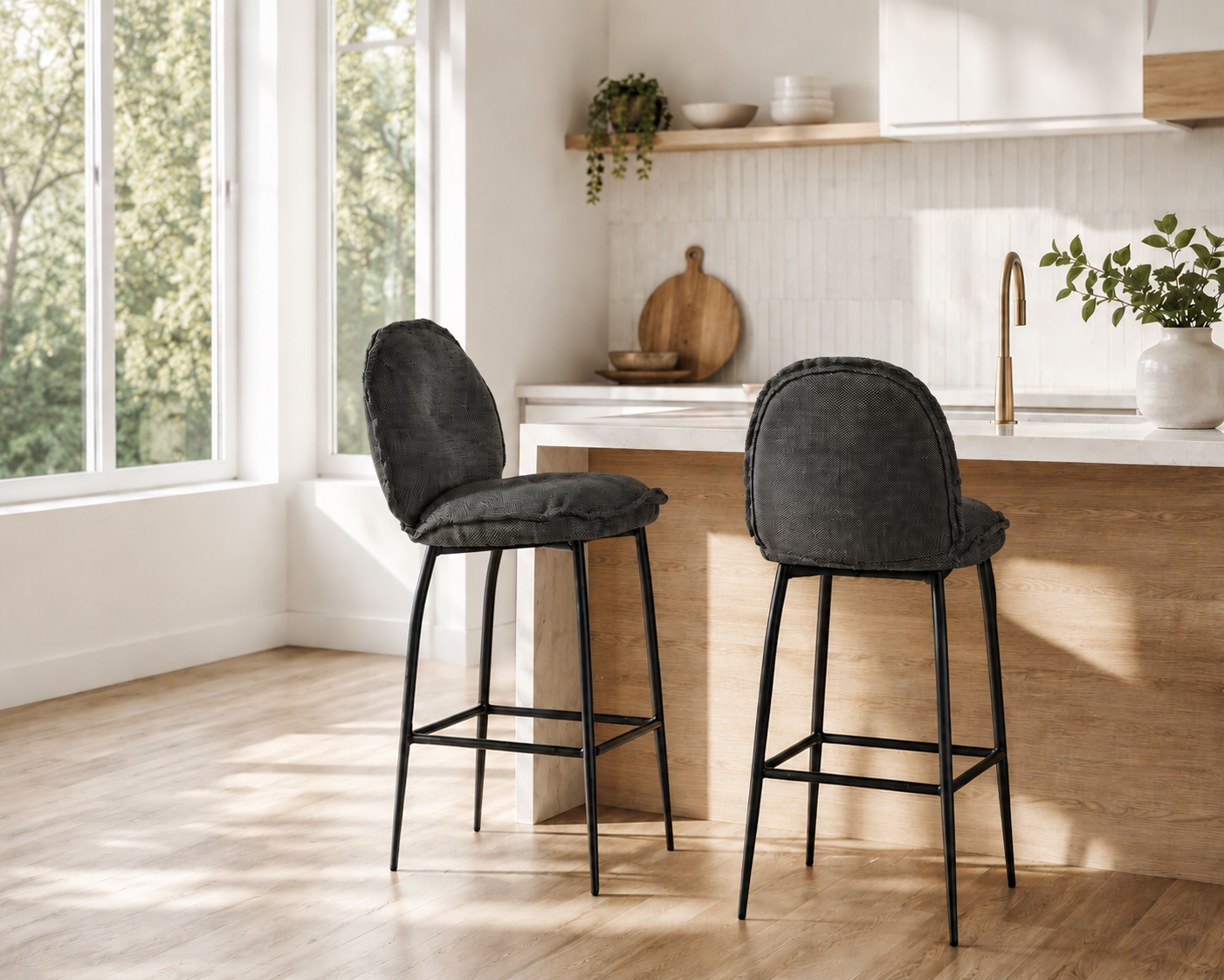 Two dark gray bar stools in a kitchen setting with natural light.